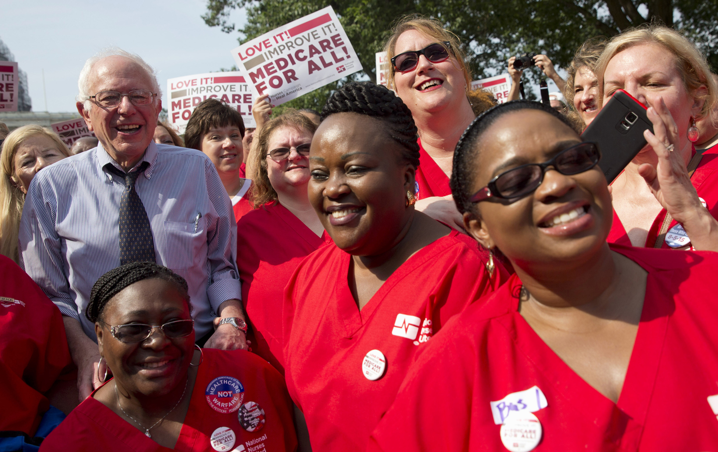 Democratic presidential candidate, Sen. Bernie Sanders, I-Vt., left, poses with a group of nurses after speaking at a rally on the 50th anniversary of Medicare and Medicaid, Thursday, July 30, 2015, on Capitol Hill in Washington. (AP Photo/Jacquelyn Martin)